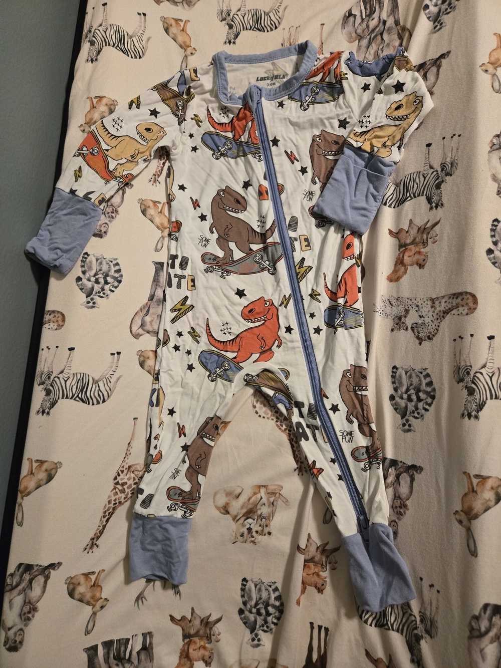 Lucky Elk Brand Dino Skate Footed One-Piece Pajamas - White with Blue Trim